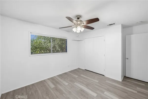 a view of an empty room with a fireplace and a window