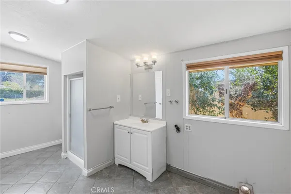 a white house with a large tree in front of it