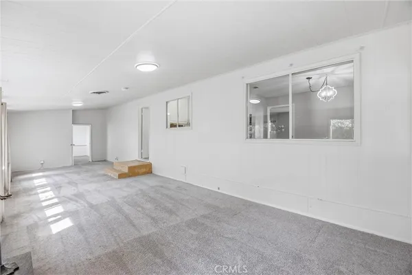 a view of a balcony with wooden floor and iron fence
