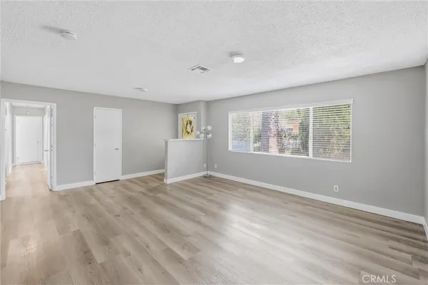 a view of kitchen with granite countertop cabinets and window