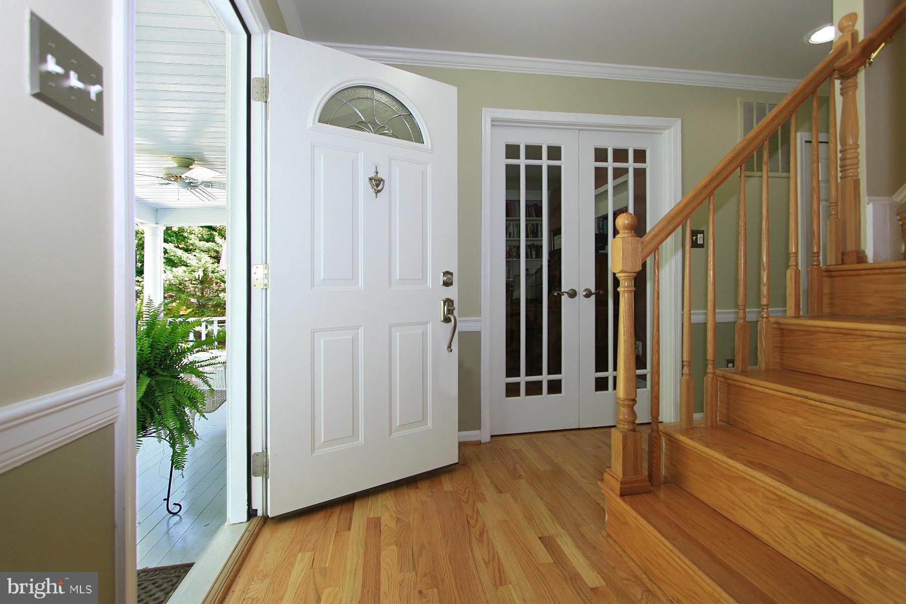 1613 Stowe Road Reston, VA 20194 - Photo 3 of 30 a view of a hallway with wooden floor and staircase