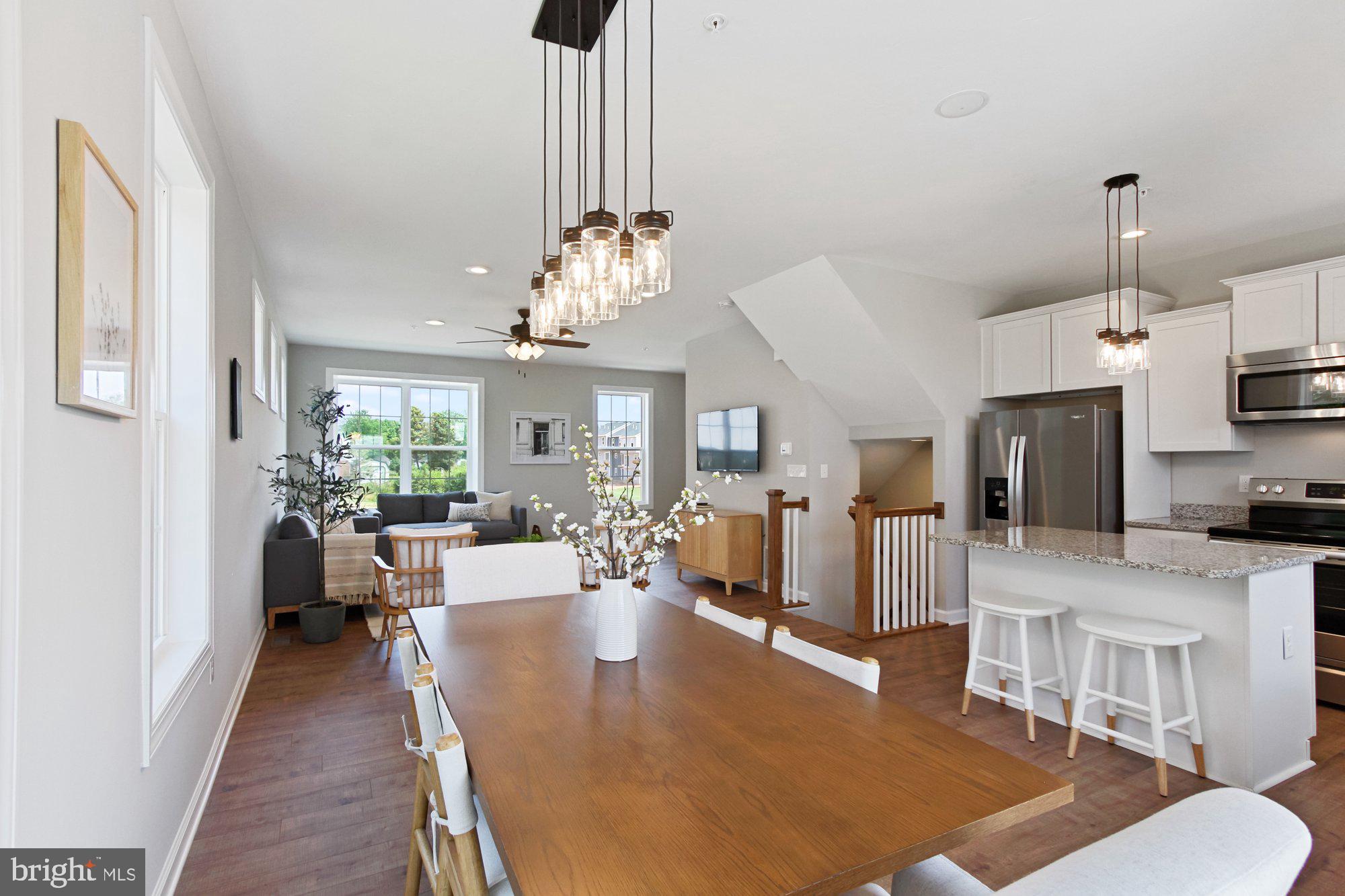 436 Bradford Drive, Unit 59 Red Lion, PA 17356 - Photo 13 of 43 a living room with furniture a chandelier and a dining table