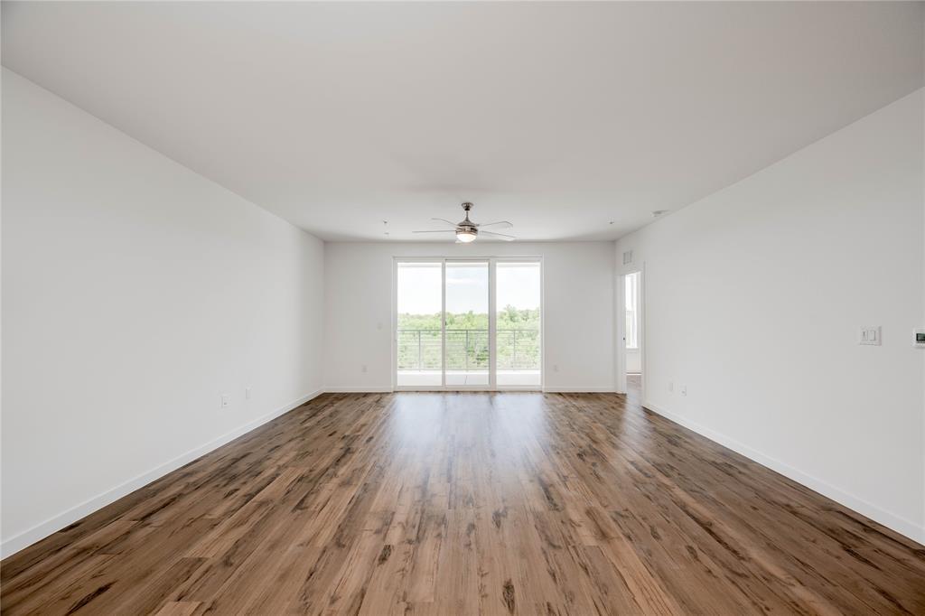 4801 Springdale Road, Unit 1307 Austin, TX 78723 - Photo 7 of 30 a view of an empty room with wooden floor and a window