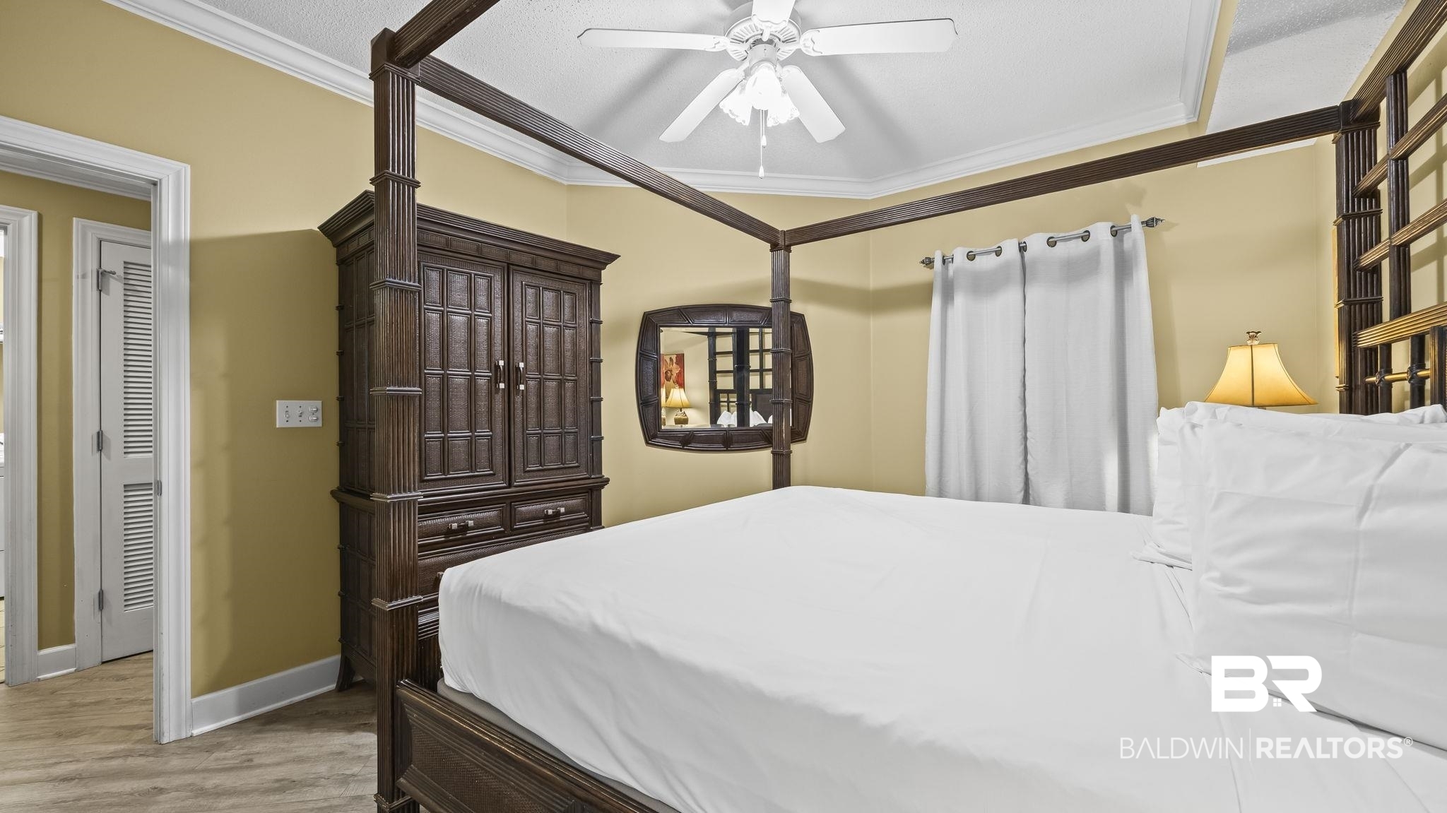 27580 Canal Road, Unit 214 BS 62 Orange Beach, AL 36561 - Photo 7 of 23 Bedroom with light wood-style floors, crown molding, and a ceiling fan