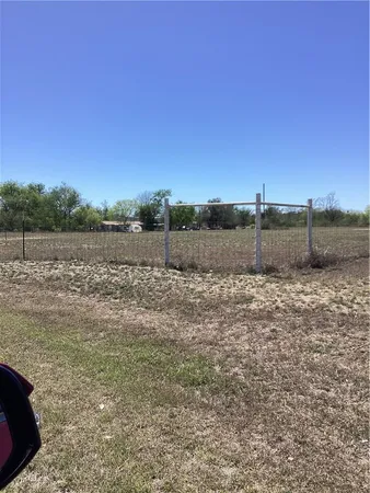 a view of a yard with wooden fence