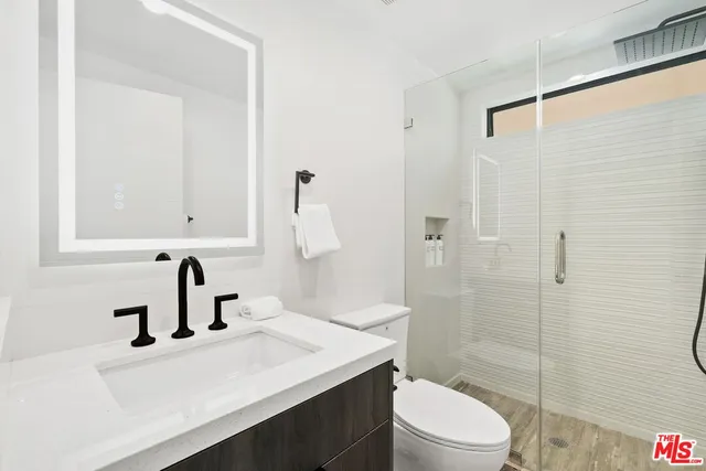 a bedroom with a large bed and a flat screen tv