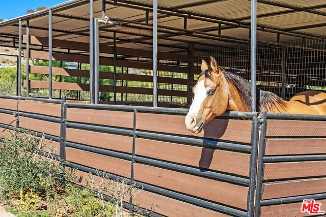 a sign board with buildings in the background