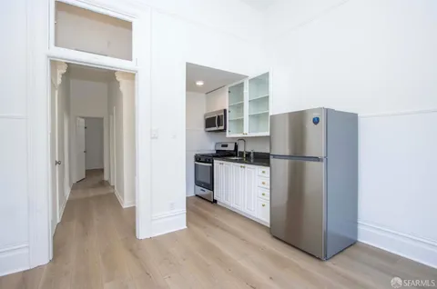 a kitchen with a refrigerator and a sink