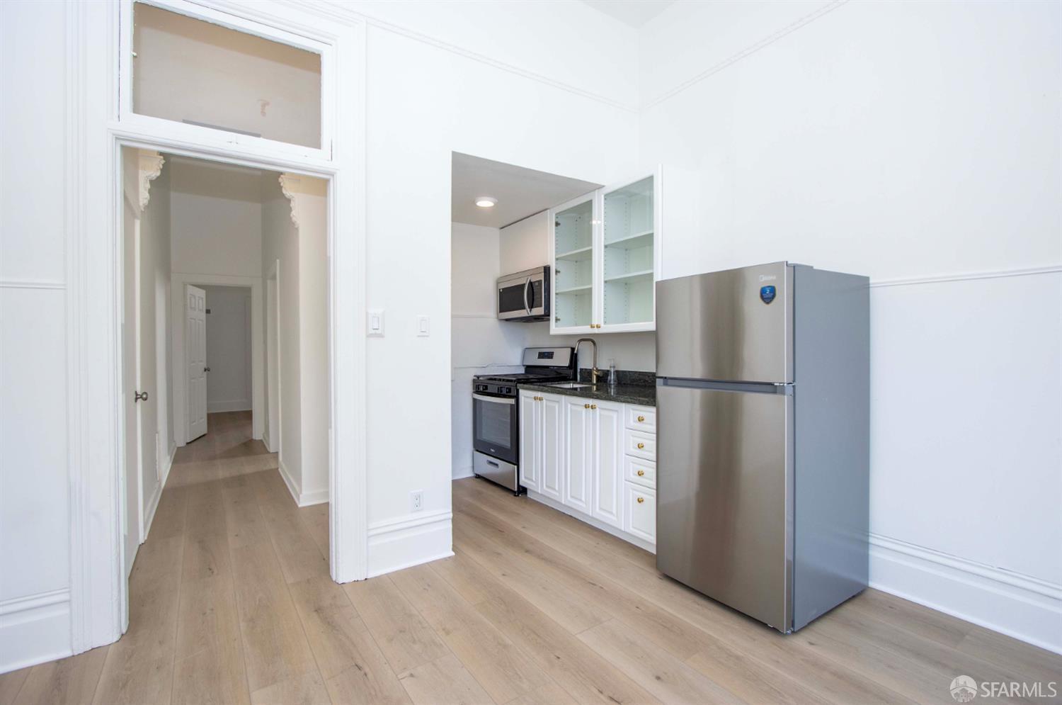 2976 Mission Street San Francisco, CA 94110 - Photo 2 of 21 a kitchen with a refrigerator and a sink