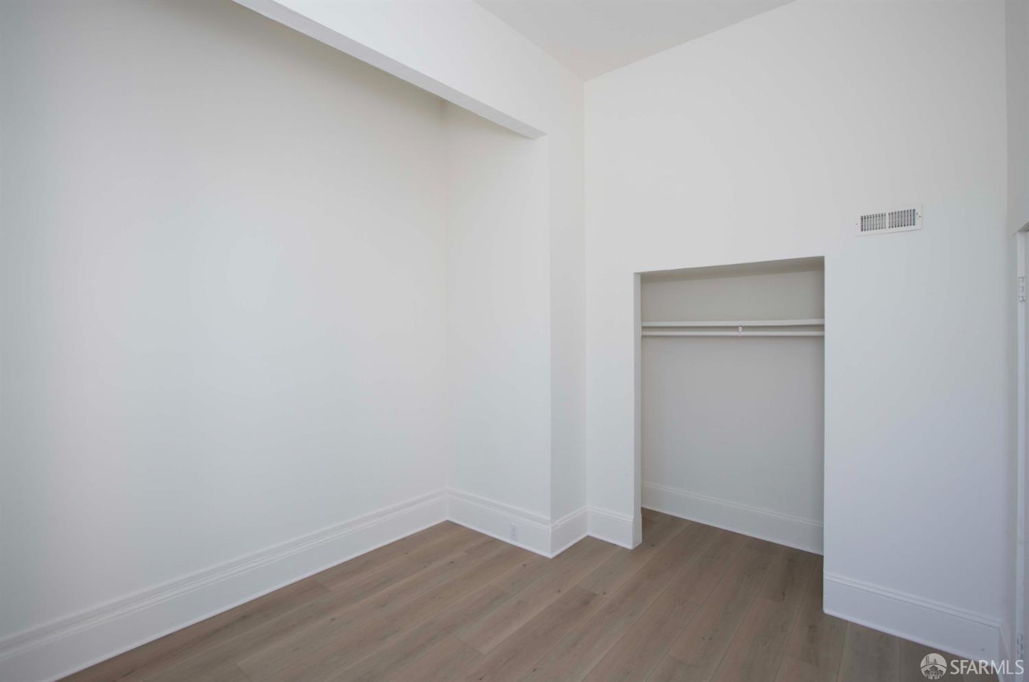 2976 Mission Street San Francisco, CA 94110 - Photo 5 of 21 a view of an empty room with closet and wooden floor