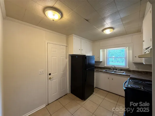 a kitchen with a refrigerator and a sink