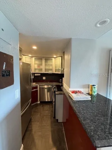 a kitchen with a stove and a refrigerator