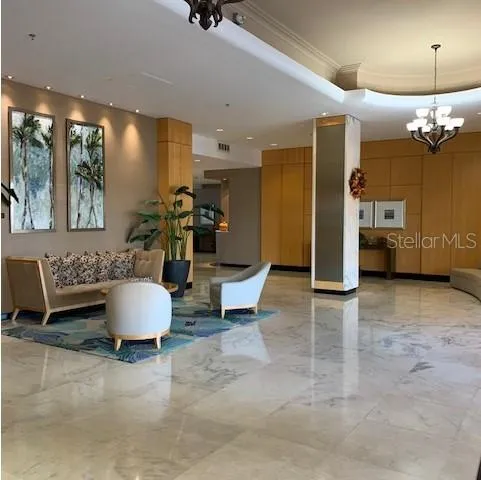 a living room with furniture a window and a chandelier