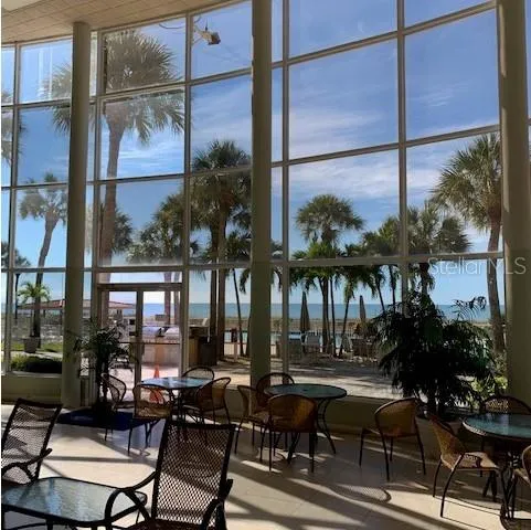 a view of a workspace with furniture and a potted plant