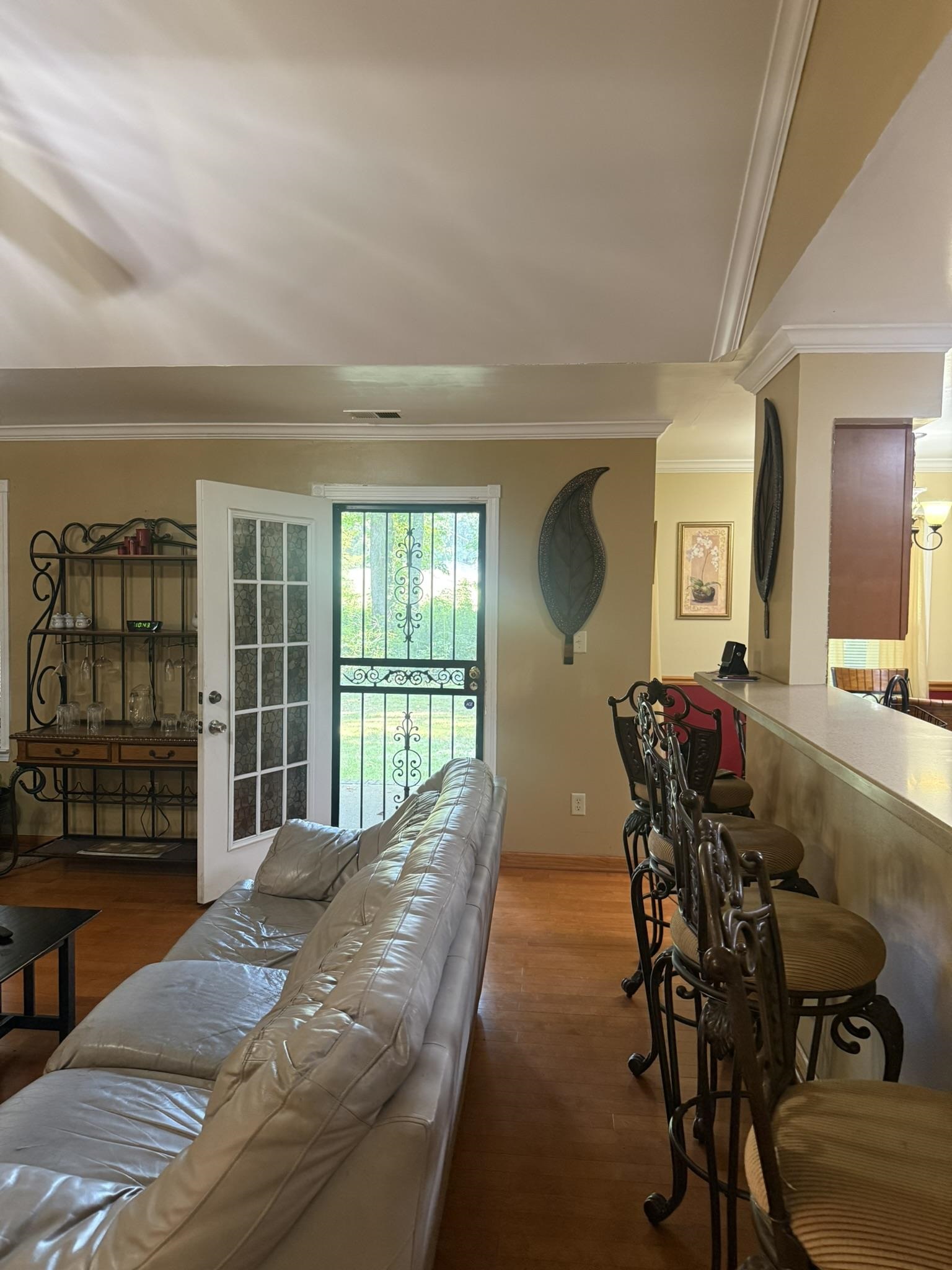 4532 Kassell Road Memphis, TN 38116 - Photo 13 of 39 Wood-finish flooring, crown molding, and a built-in breakfast bar define this living area