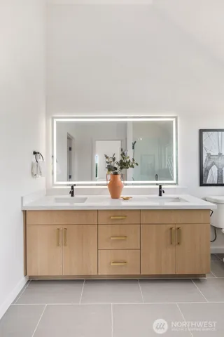 a bathroom with a sink double vanity and a mirror