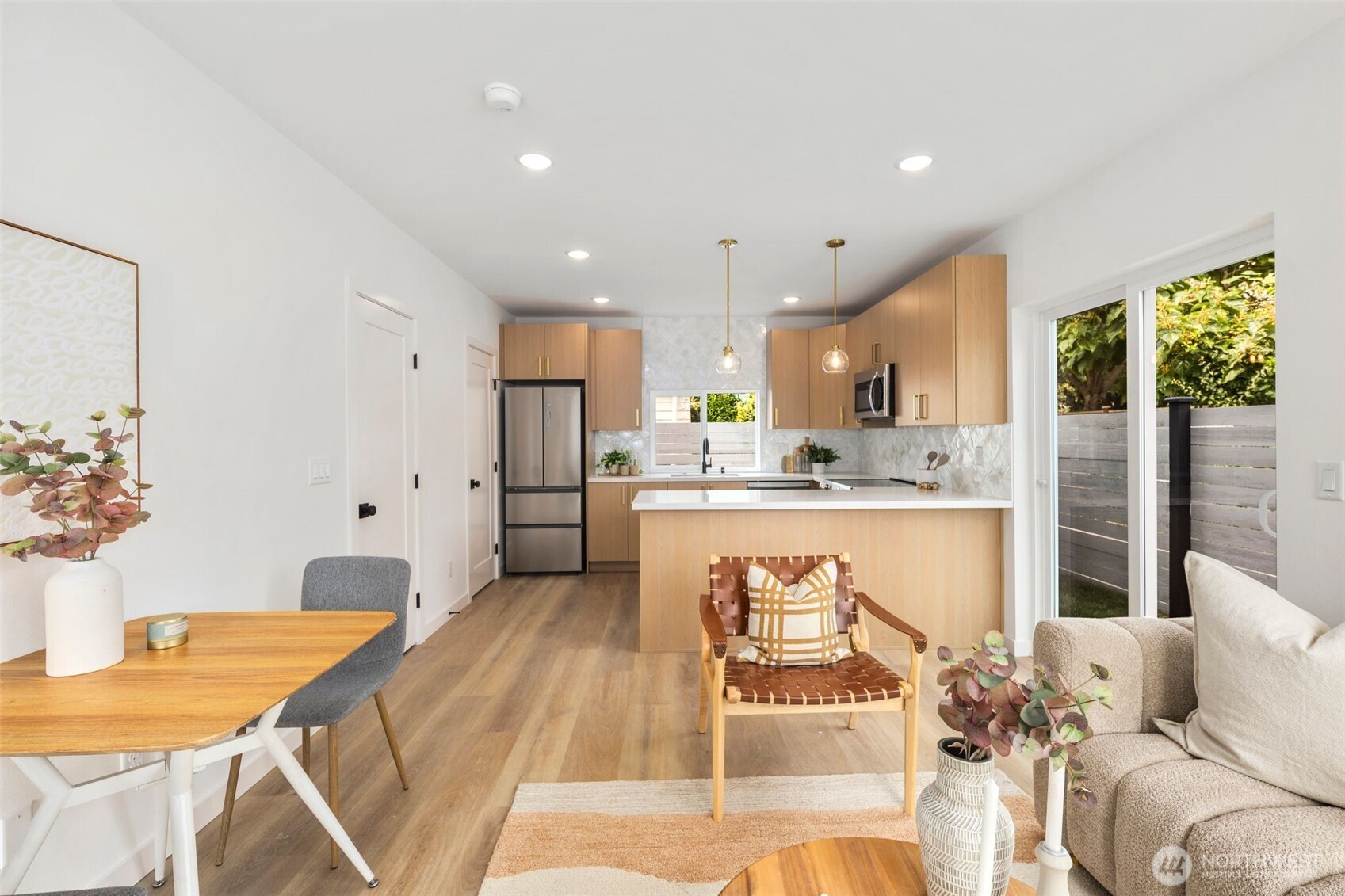 822 South Sullivan Street Seattle, WA 98108 - Photo 4 of 22 a living room with stainless steel appliances kitchen island granite countertop furniture and a wooden floor