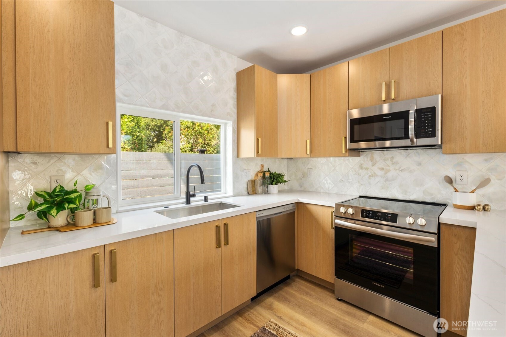 822 South Sullivan Street Seattle, WA 98108 - Photo 7 of 22 a kitchen with a sink a stove and microwave