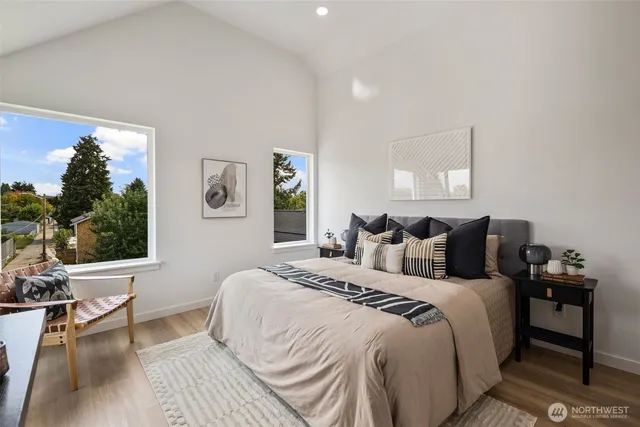 a large bedroom with a bed and wooden floor