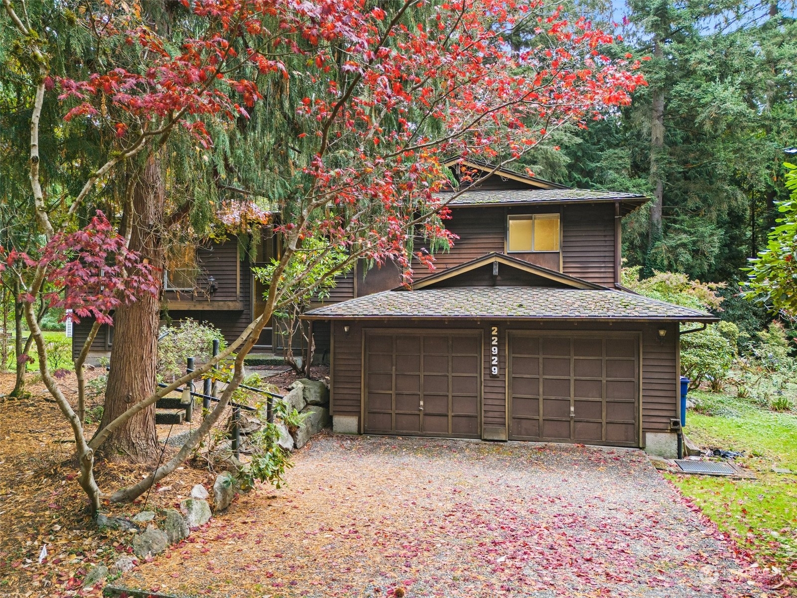 a front view of a house with a garden