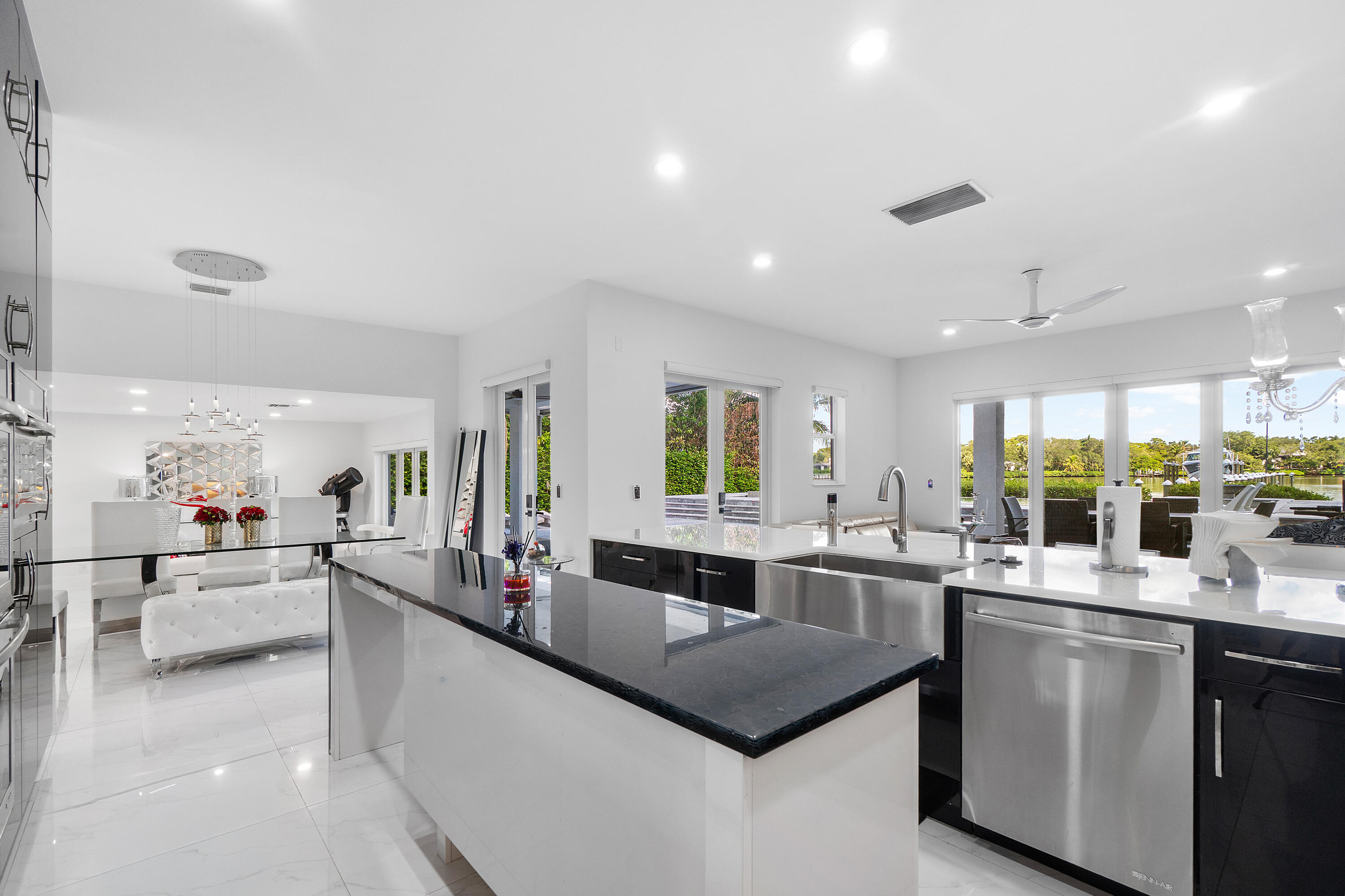 5447 Center Street Jupiter, FL 33458 - Photo 13 of 60 a large kitchen with a counter top space a sink a stove and cabinets