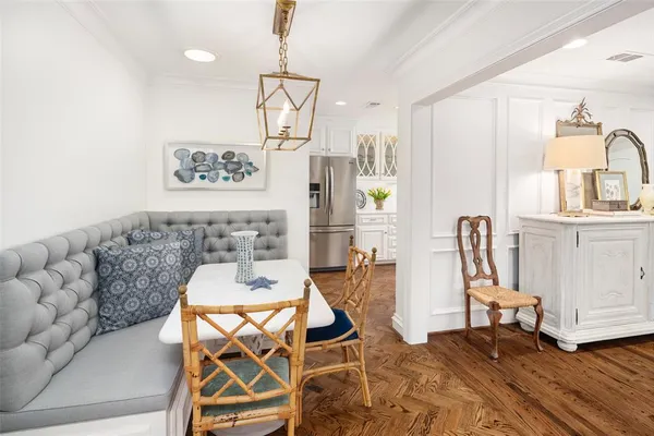 a view of a dining room with furniture and wooden floor
