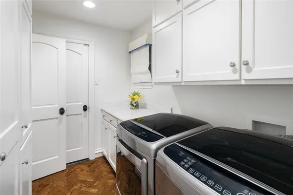 a kitchen with a stove and white cabinets