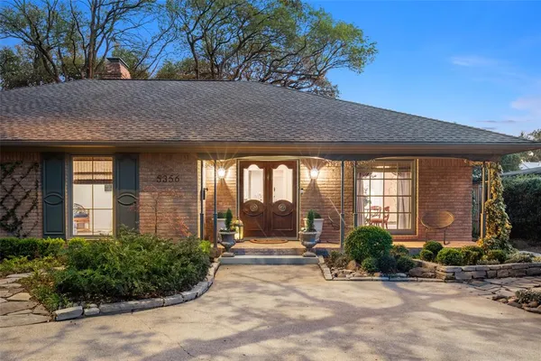 a front view of house with a garden