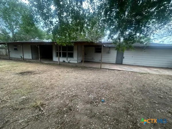 a view of a field with trees in front of it