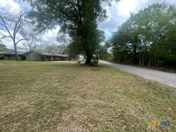 a large kitchen with stainless steel appliances a large counter top a stove a chimney a sink and a refrigerator