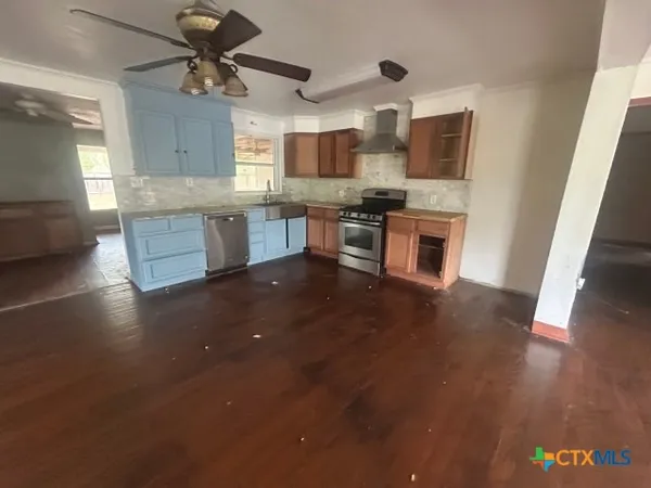 a view of a livingroom with a ceiling fan and window
