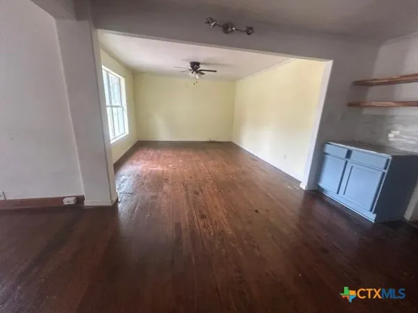 an empty room with windows and entrance