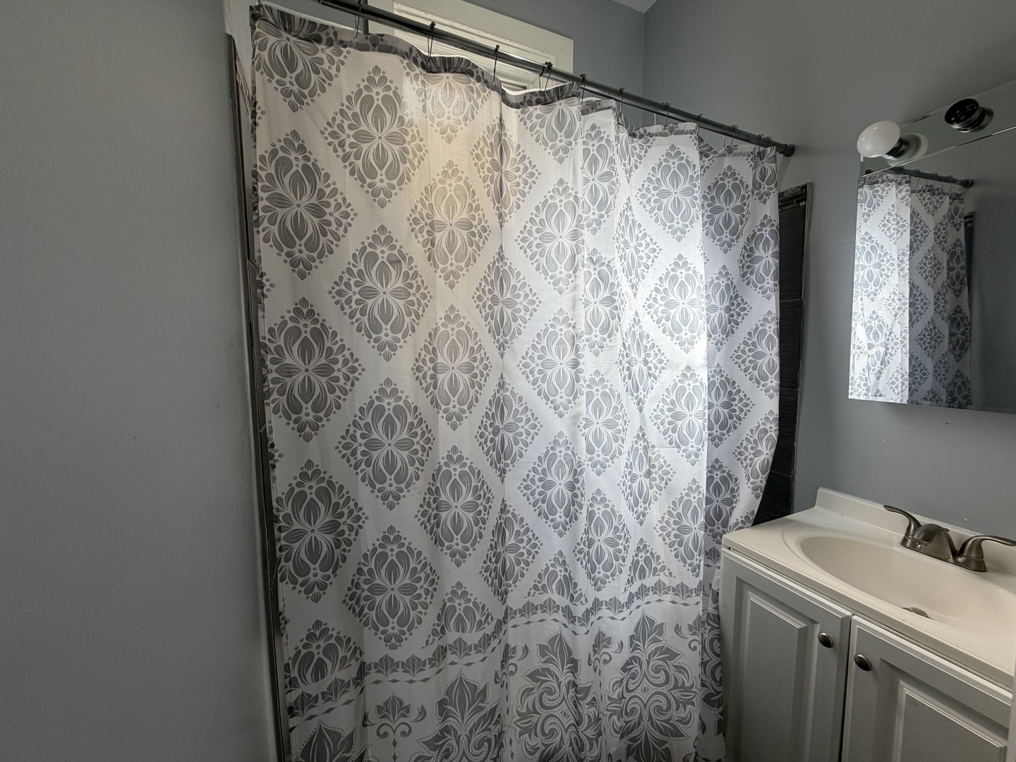 6006 South Marshfield Avenue, Unit 1 Chicago, IL 60636 - Photo 12 of 14 a bathroom with a shower curtain and sink