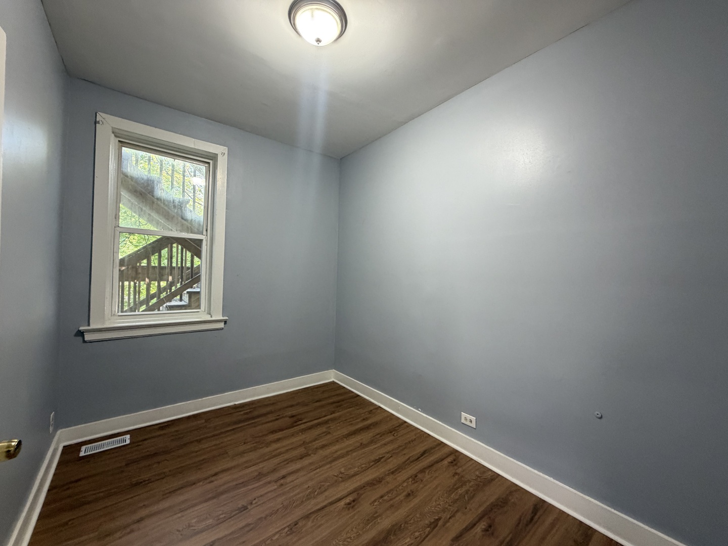 6006 South Marshfield Avenue, Unit 1 Chicago, IL 60636 - Photo 14 of 14 an empty room with wooden floor and windows