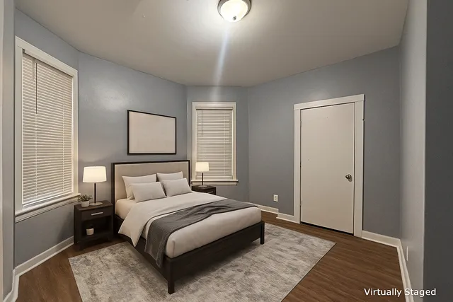 a bedroom with a bed and a night stand