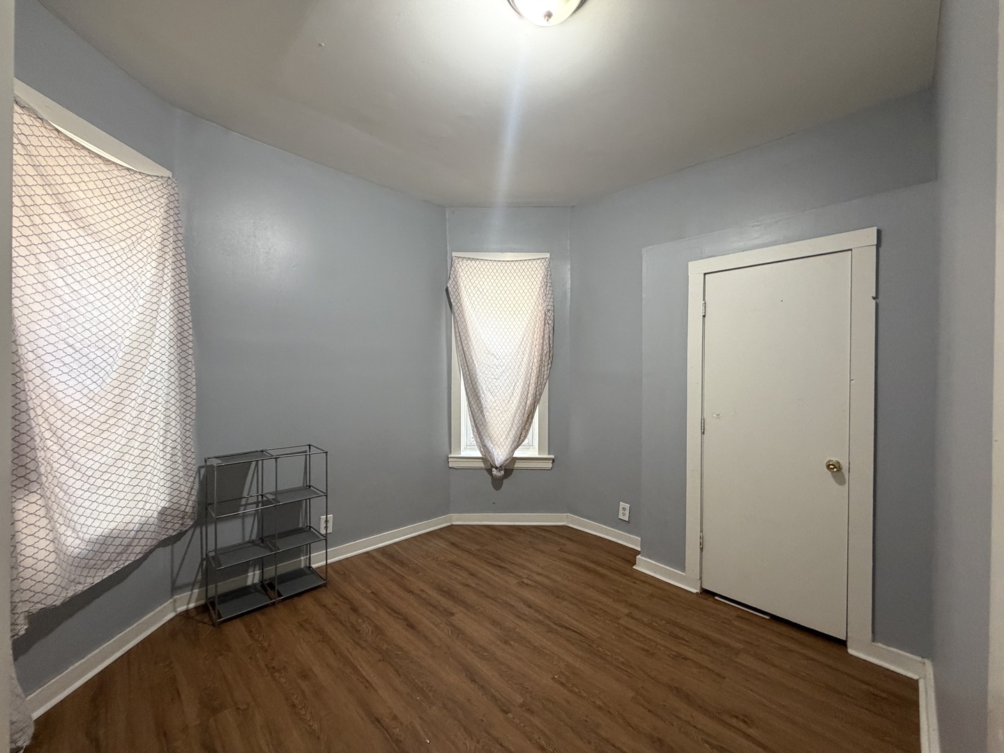 6006 South Marshfield Avenue, Unit 1 Chicago, IL 60636 - Photo 6 of 14 an empty room with wooden floor and windows