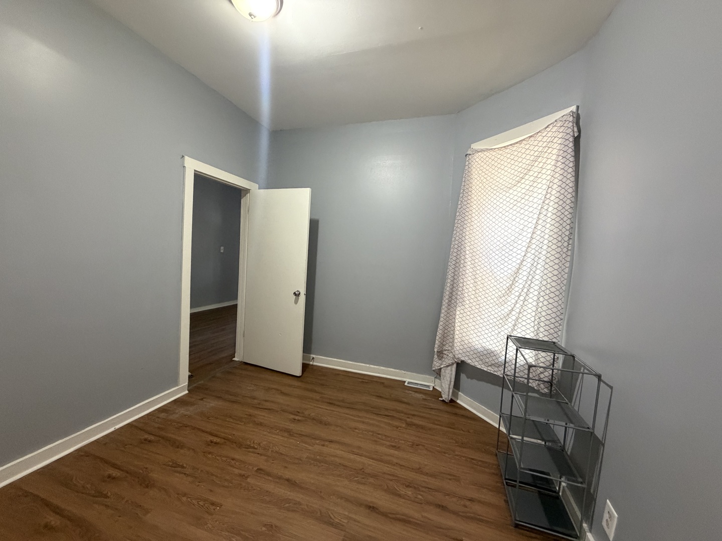 6006 South Marshfield Avenue, Unit 1 Chicago, IL 60636 - Photo 7 of 14 an empty room with wooden floor and windows