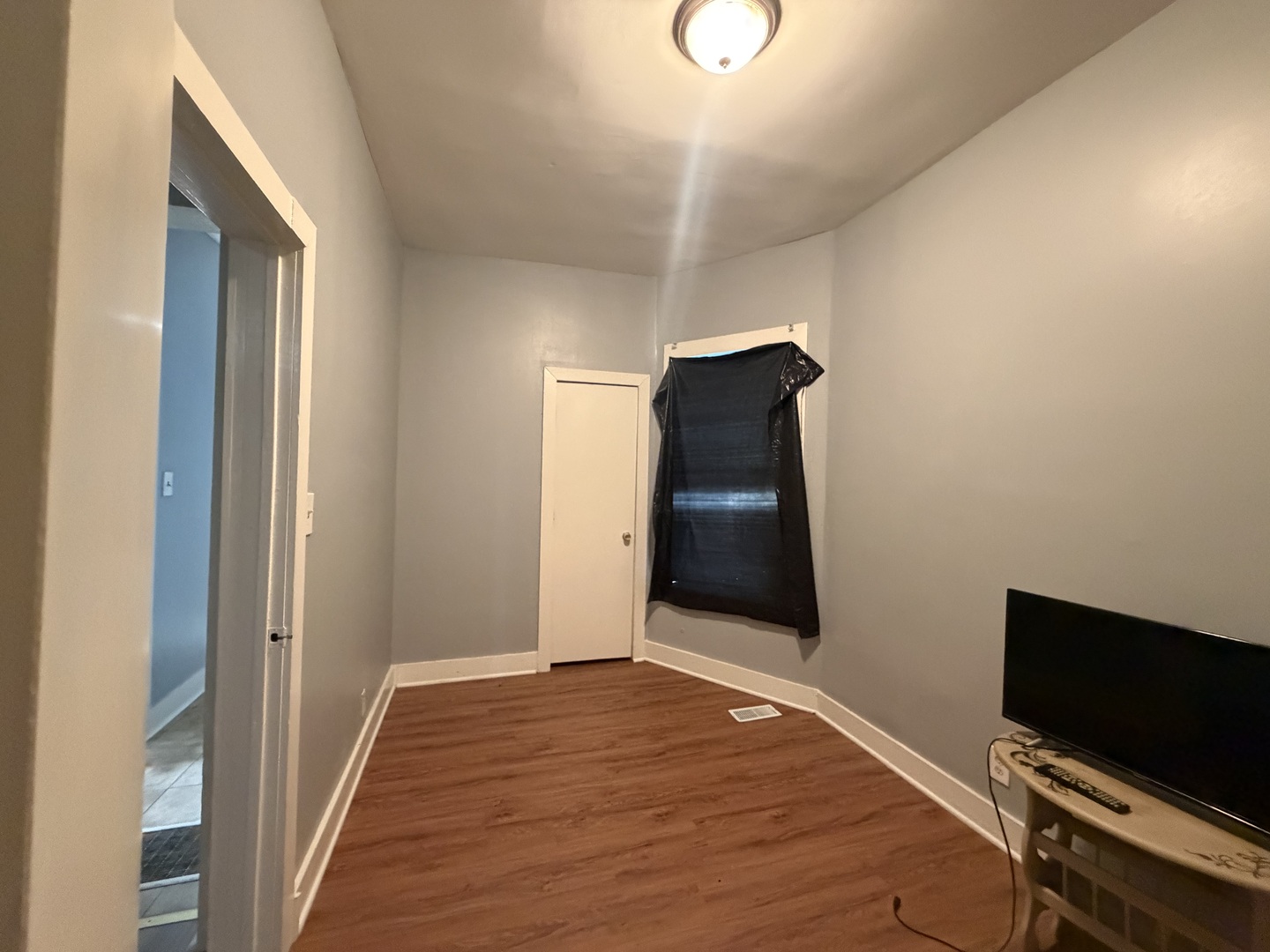 6006 South Marshfield Avenue, Unit 1 Chicago, IL 60636 - Photo 9 of 14 a view of a livingroom with wooden floor and wardrobe