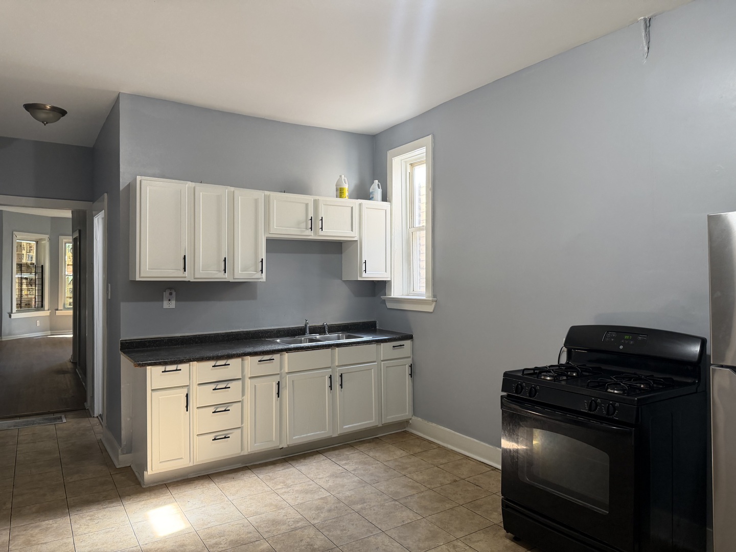 6006 South Marshfield Avenue, Unit 1 Chicago, IL 60636 - Photo 10 of 14 a kitchen with stainless steel appliances granite countertop a stove a sink and a microwave