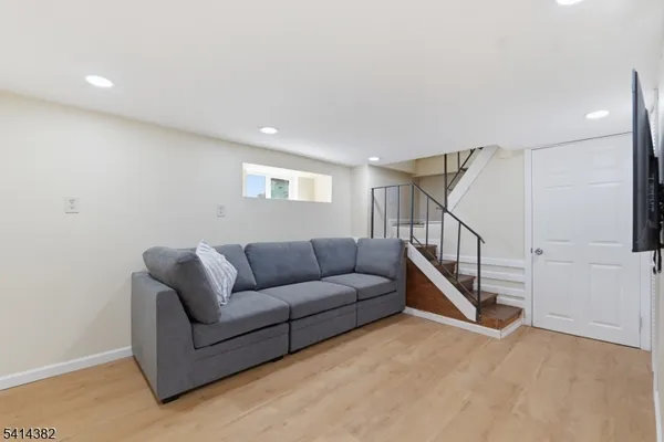 a living room with furniture and stairs