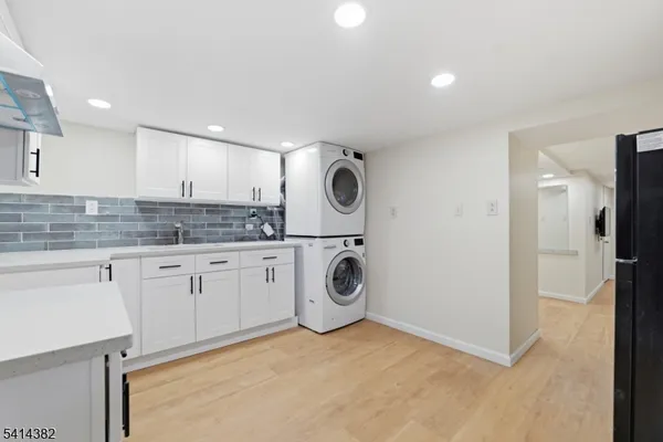 a utility room with sink dryer and washer