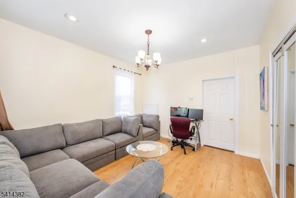 a living room with furniture and a chandelier