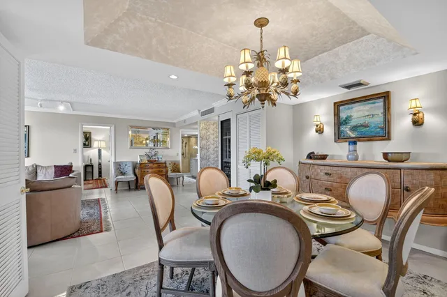 a dining room with furniture and chandelier