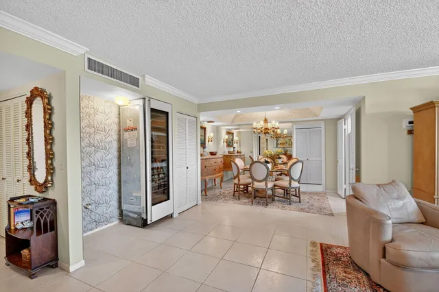 a view of a dining room with furniture and chandelier