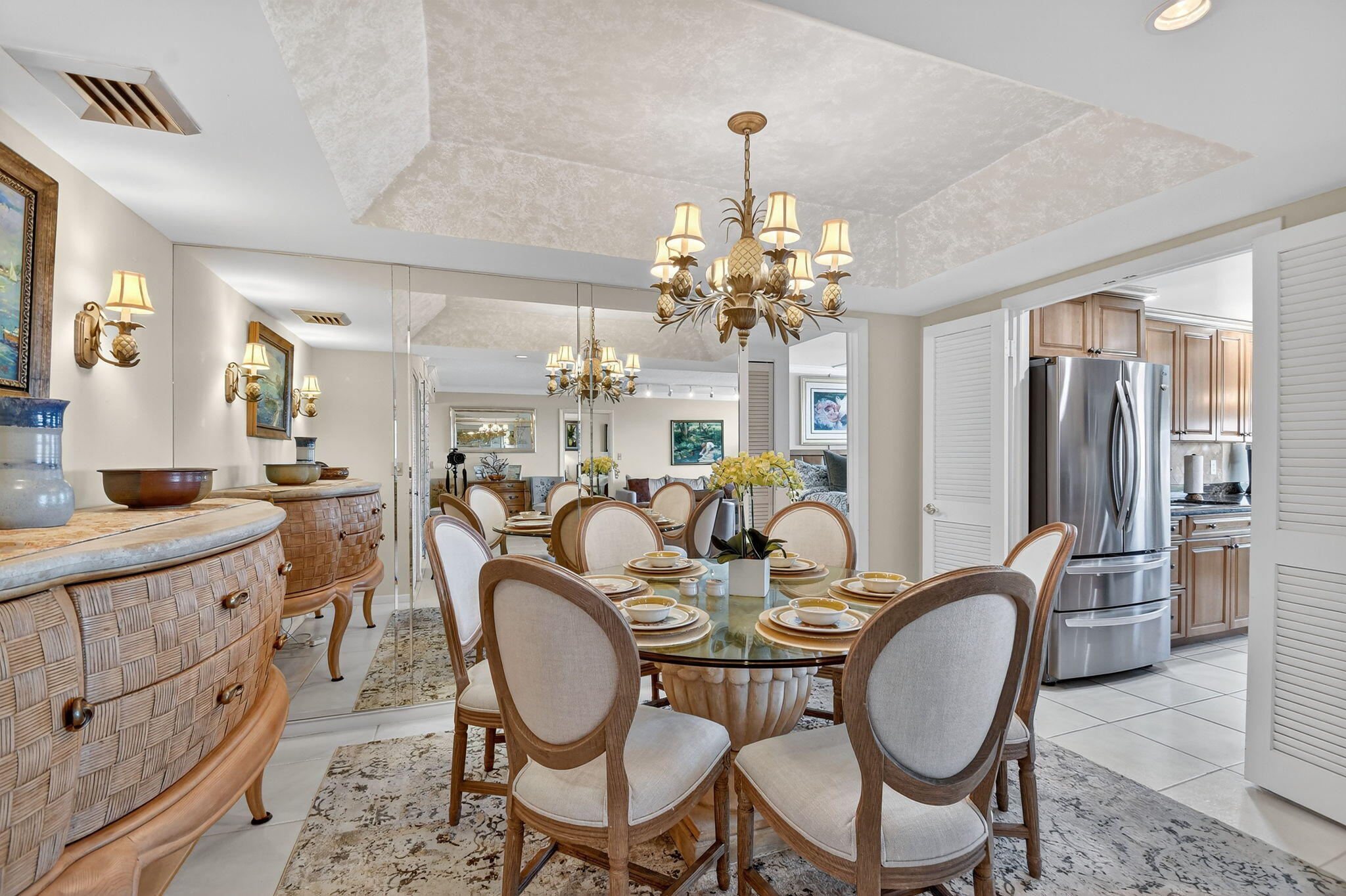3589 South Ocean Boulevard, Unit 608 South Palm Beach, FL 33480 - Photo 14 of 66 a dining room with furniture a chandelier and wooden floor