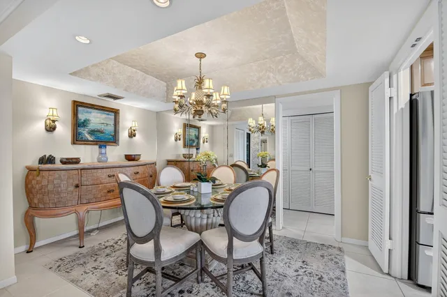 a bed room with a bed and a chandelier