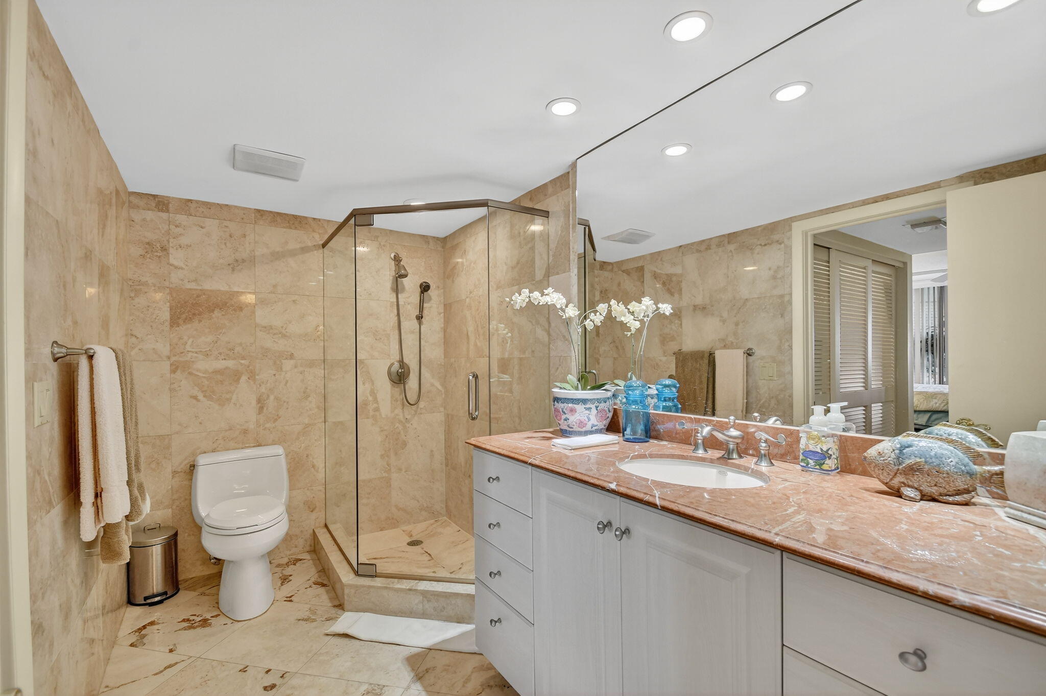 3589 South Ocean Boulevard, Unit 608 South Palm Beach, FL 33480 - Photo 27 of 66 a bathroom with a double vanity sink toilet and shower