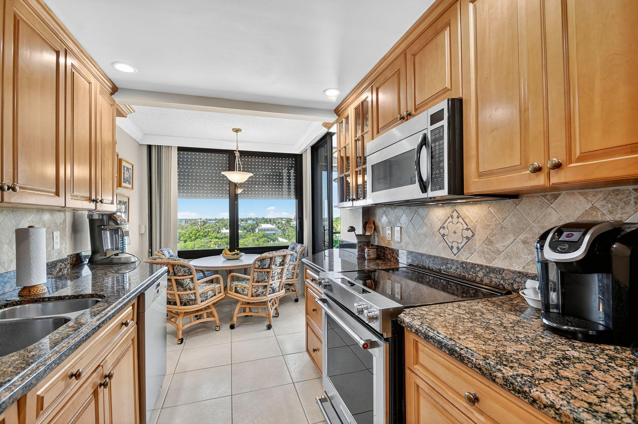 3589 South Ocean Boulevard, Unit 608 South Palm Beach, FL 33480 - Photo 29 of 66 a kitchen with a stove and a sink