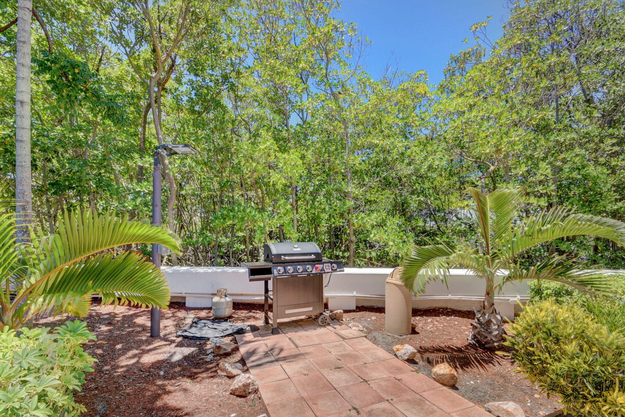 3589 South Ocean Boulevard, Unit 608 South Palm Beach, FL 33480 - Photo 56 of 66 a view of a backyard with sitting area