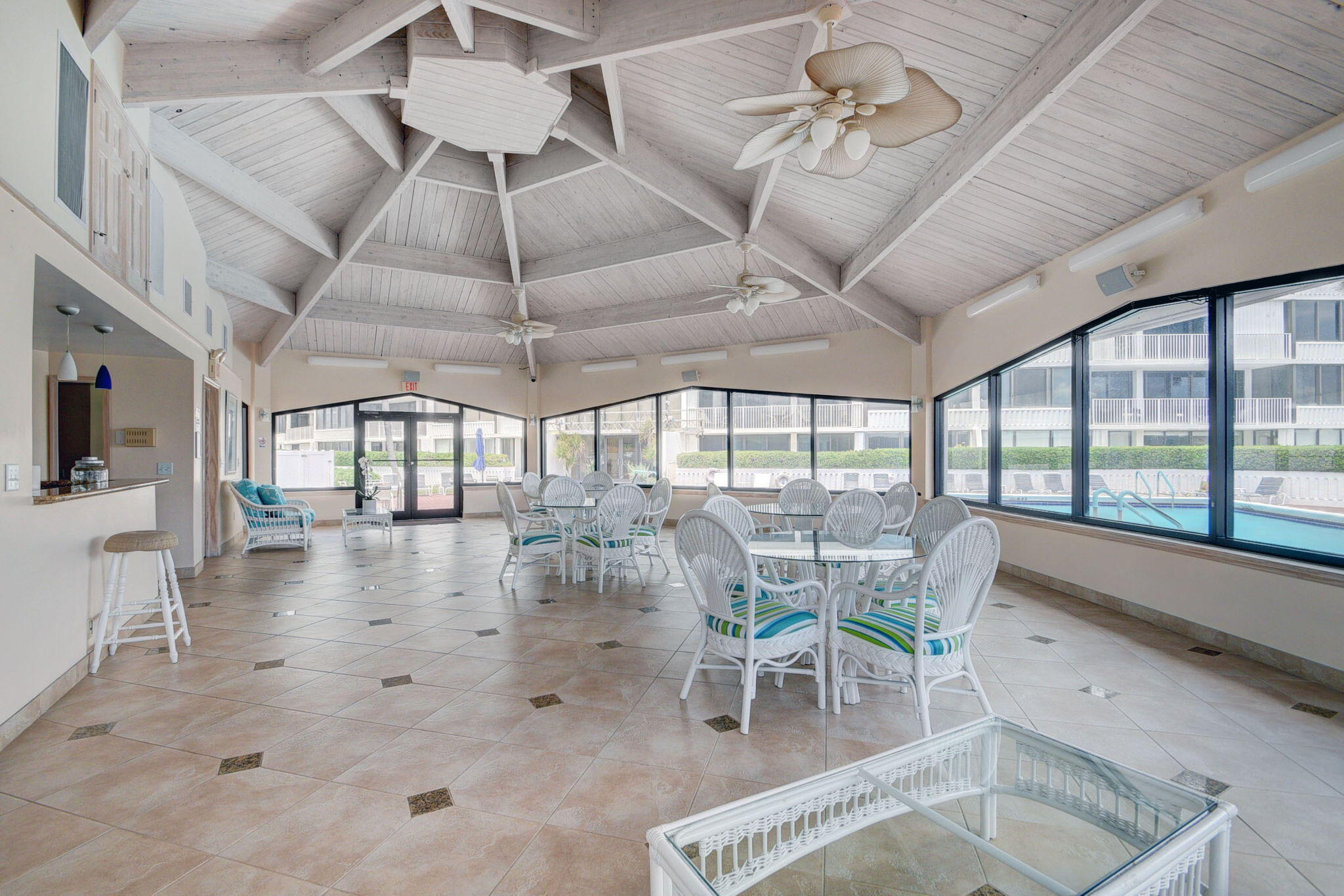 3589 South Ocean Boulevard, Unit 608 South Palm Beach, FL 33480 - Photo 63 of 66 a dining room with wooden floor a chandelier a glass table and chairs
